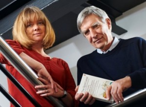 Authors Kate Pickett and Richard Wilkinson displaying a copy of their book, The Spirit Level